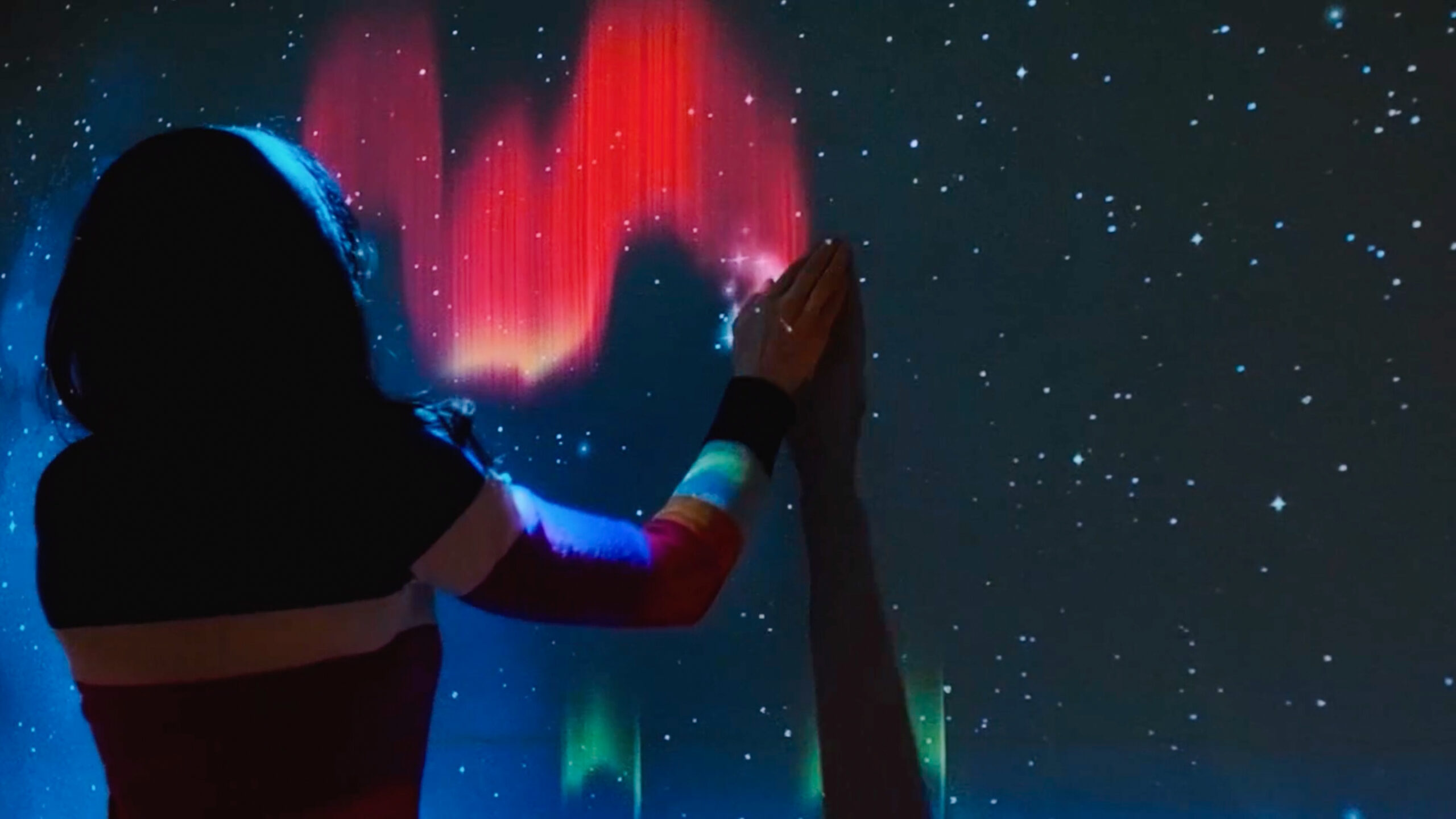 A person screen painting auroras.